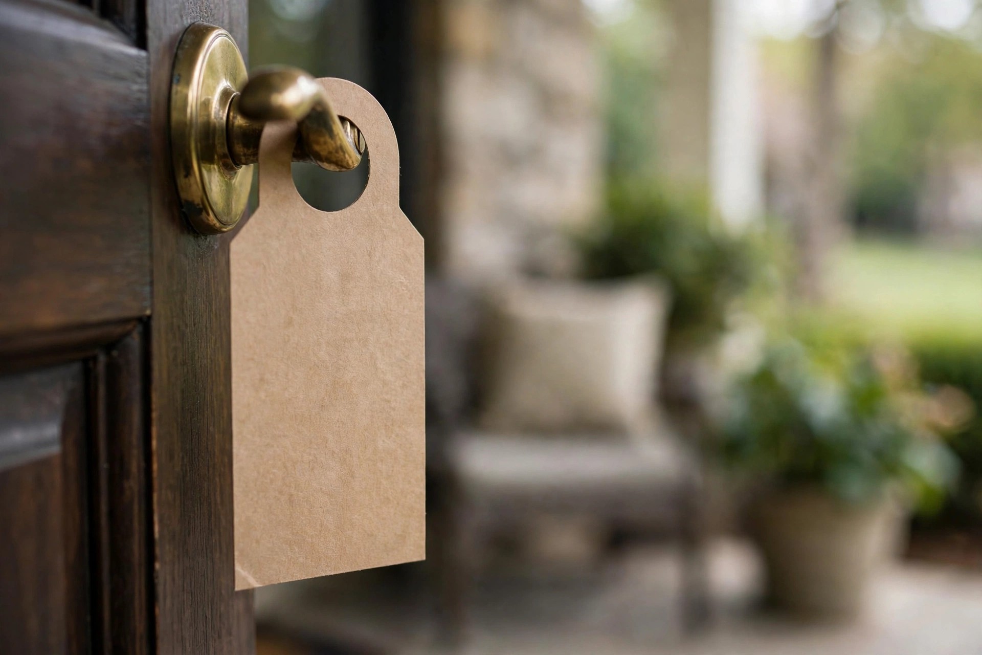 Pest Control Marketing Ideas That Fill the Schedule Blank door hanger tag hanging on a residential front door handle with a suburban porch behind