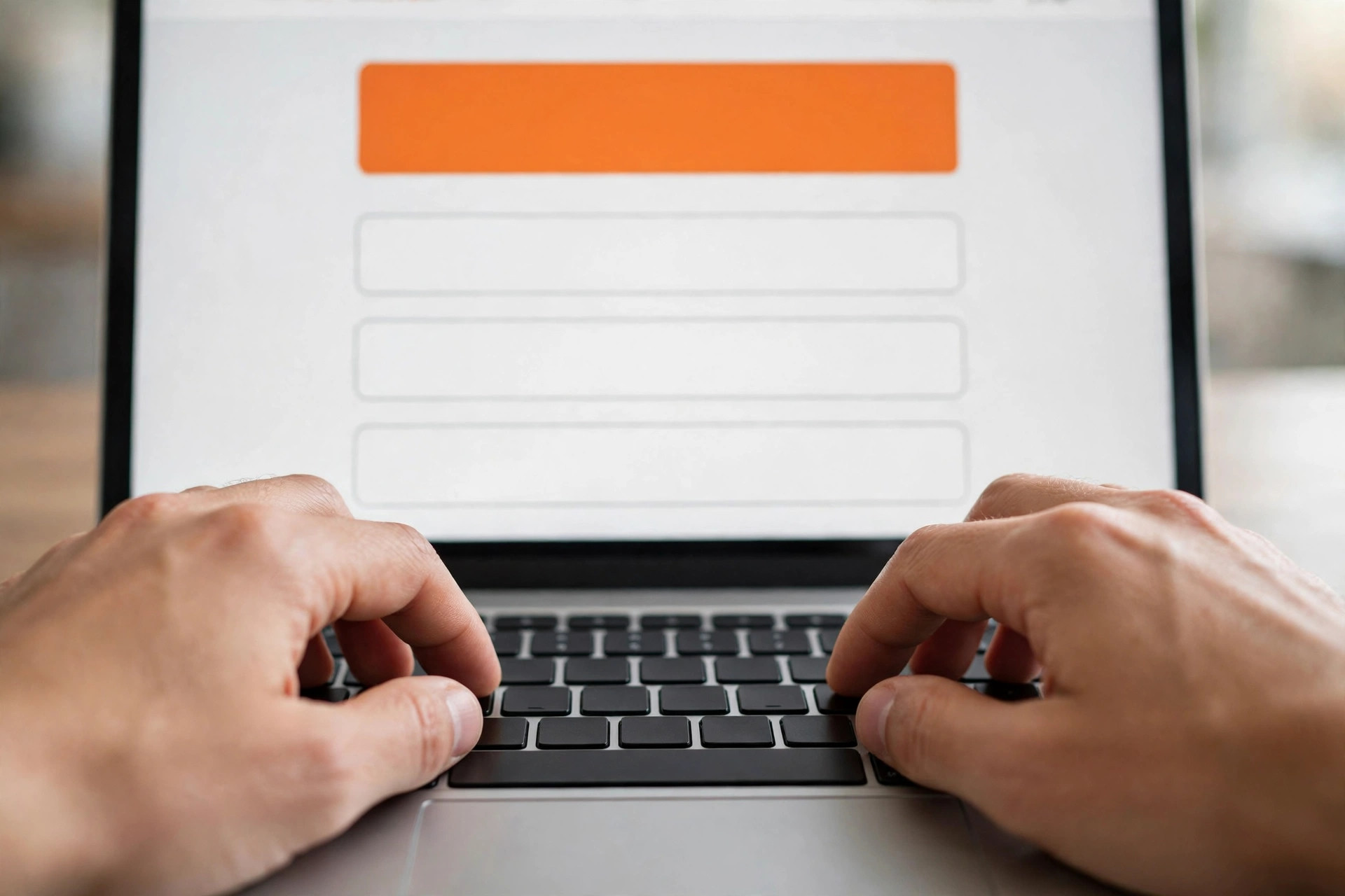 Landing Page Conversion Rate Optimization Hands typing on a laptop showing a landing page with a large call to action button